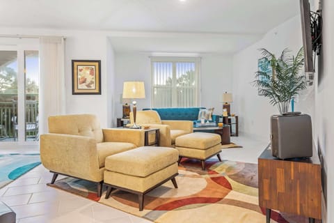 Bright living room with comfortable seating and a colorful area rug