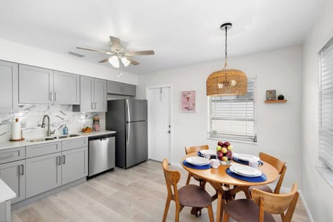 Head out the kitchen door to find the side patio complete with a grill, table, chairs, and lighting.