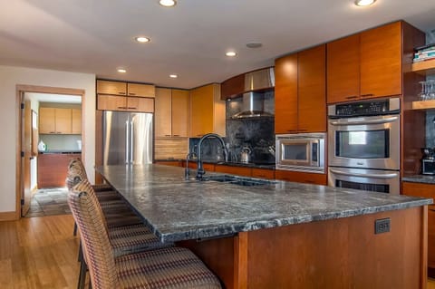 Expansive kitchen and seating area over soapstone countertops