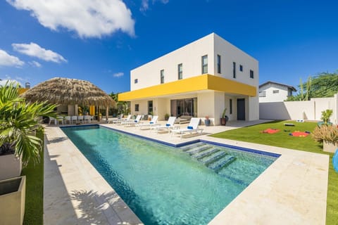 Relax and unwind in the expansive pool, offering plenty of space to swim, sunbathe, and enjoy the perfect outdoor escape.