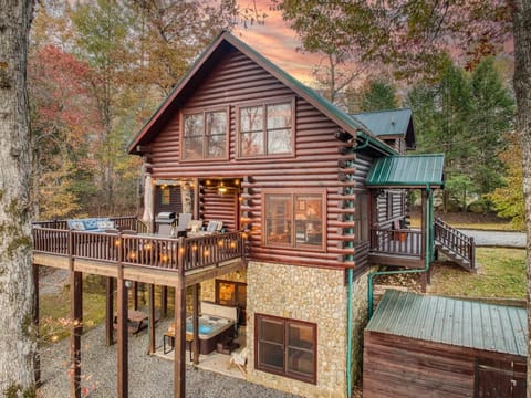 Outside view of cabin, deck, and hot tub