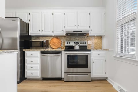 Whip up your favorite meal in the fully stocked kitchen with stainless steel appliances.