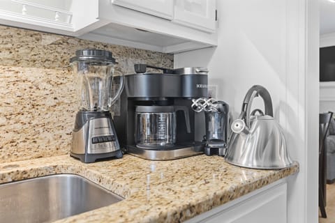 The kitchen is equipped with a blender, coffee/keurig combination, hand mixer, and tea kettle for all your cooking and beverage needs.