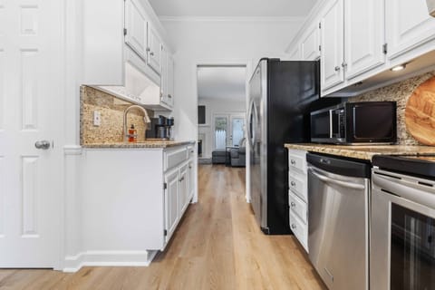The kitchen, with its granite countertops, seamlessly opens into the dining room, creating a perfect space for cooking and gathering.