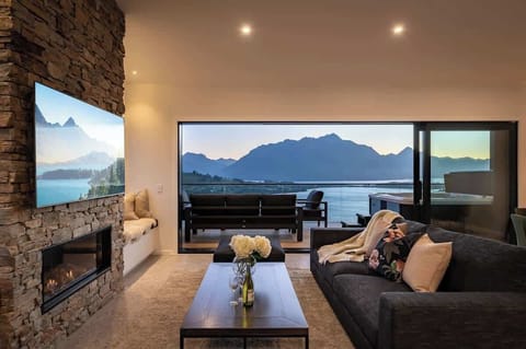 The expansive windows frame the breathtaking scenery, creating a perfect balance of comfort and natural beauty. 