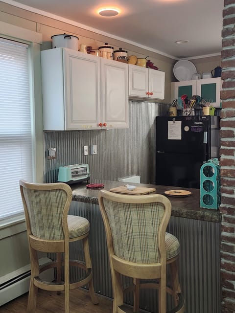 Bar with Concrete counter tops/toaster/cutting boards/Bar stools/glow can lights