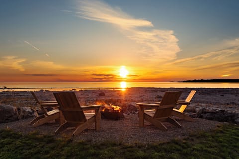 Immerse yourself in breathtaking Lake Huron views. This 1.1-acre property feels like an island retreat, with the sounds of nature. Enjoy a spacious backyard, a separate fire pit, and the best sunset spot in Tobermory.