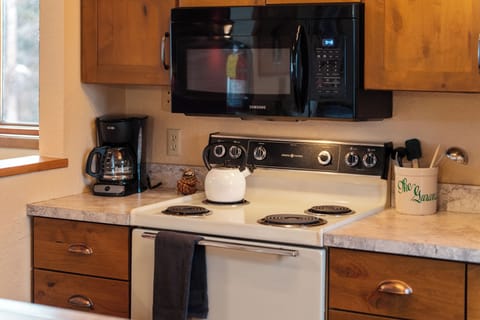 Cooking made easy! This kitchen is all about convenience with a microwave and refrigerator ready to whip up delicious meals in no time