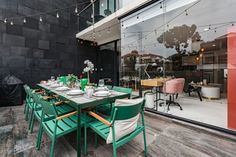 Patio dining space complete w/ string lights, creating a magical atmosphere for evening gatherings.