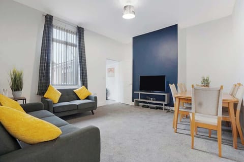 An open-plan living room, dining area and kitchen benefit from a SMART TV with Netflix, and plenty  of space to sit down and relax. 