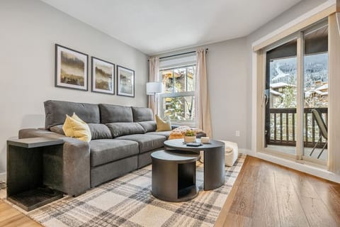 Living room with a 42` Smart TV with cable, gas fireplace and a cozy sectional with a pull-out sofa bed (bedding is provided.)
