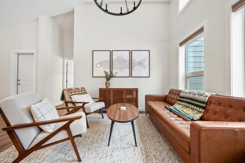 Beautifully designed living room on the main floor with cozy seating and plenty of natural lighting.