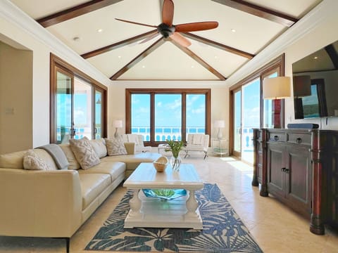 Relax in the bright living room with ocean views and tropical charm.