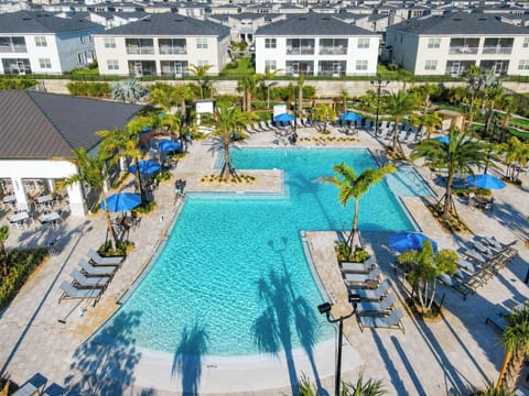 Resort Swimming Pool with Sun Loungers and Palm Trees