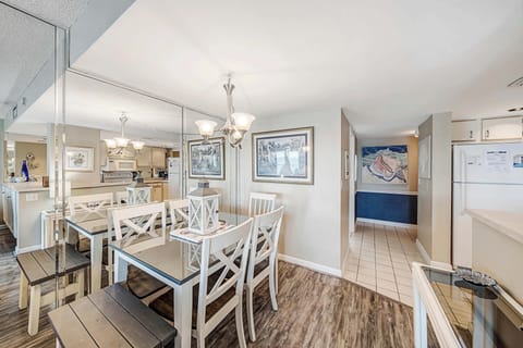 There is a large dining table, perfect for enjoying a meal or playing a game.