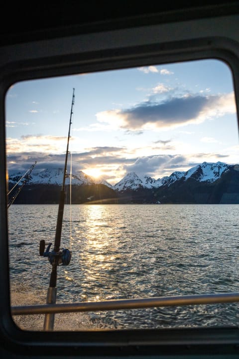 Classic Alaska waterfront scenery with fishing access and panoramic mountain views at sunset.