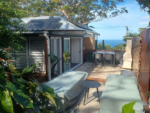 Ocean View outdoor area with wood fired pizza / fire pit and sunbeds  with view!