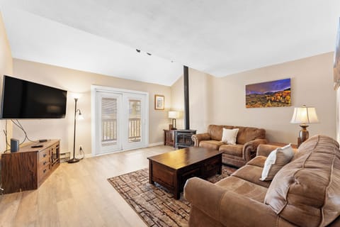 Sink into plush leather seating by your cozy fireplace while enjoying mountain views through French doors.