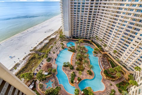 overlooking the resort-style pool and beach from a high-rise balcony