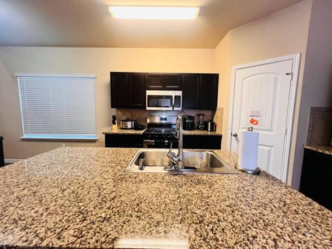 Stylish kitchen with a large island, great for meal prep and casual dining. Located near grocery stores and local dining options for convenience.

