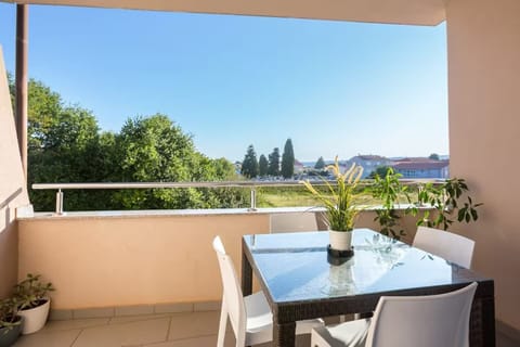 Balcony with seating for four — perfect for coffee, sun, or fresh air