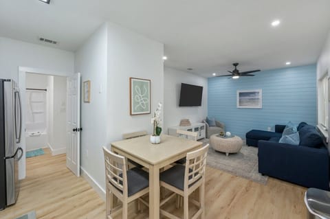 Cozy dining for four with a view of the living room and a glimpse of the bathroom entrance—designed for comfort and convenience!