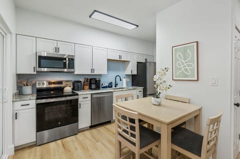 Enjoy delicious meals and great conversations in this cozy dining area, just steps away from the kitchen ready to inspire your culinary creativity.