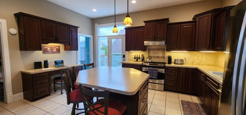 Well-equipped Kitchen with Island and Workspace.  Dish soap, dishwasher pods, garbage bags, tinfoil, plastic wrap, zip lock bags. Starter supply of coffee K-Cups and paper towel.