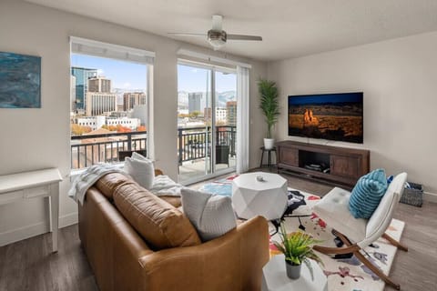 Beautifully designed living room. 75` TV, leather sleeper sofa and amazing views of mountains and city skyline.