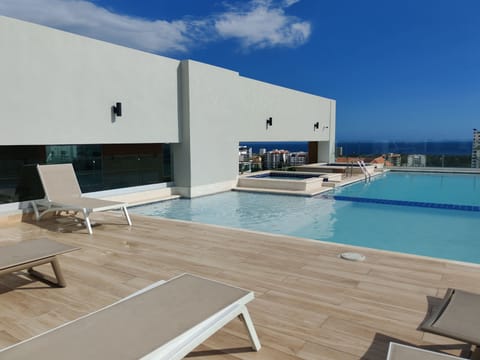 Outdoor pool, pool umbrellas, sun loungers