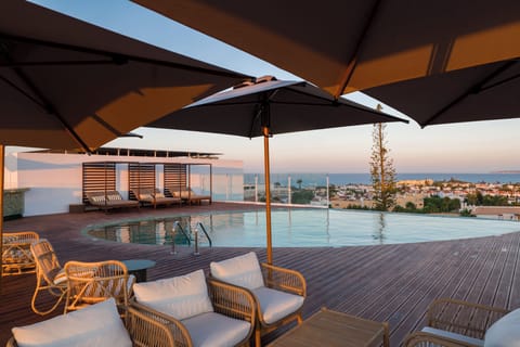Indoor pool, 2 outdoor pools, open 8:00 AM to 8:00 PM, pool umbrellas