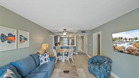Gather for a family movie night using the large wall-mounted Smart TV with easy streaming access, perfectly positioned in the comfortable living area of your renovated condo.