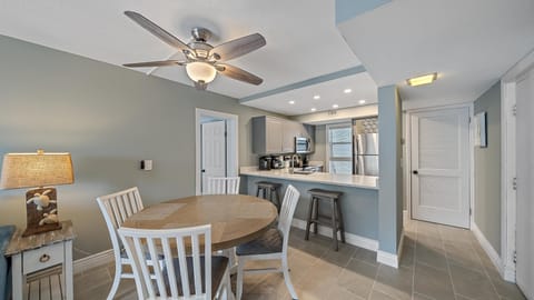 The fully renovated kitchen features new stainless steel appliances, sleek gray cabinetry, and a convenient breakfast bar, making it a joy to prepare meals during your Longboat Key getaway.