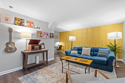 Cozy living room area with blue pull out couch, and a Talavera tile coffee table