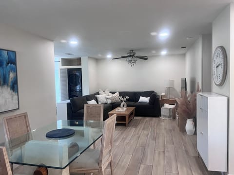 Open concept Living and Dining area with hidden washer and dryer near back door