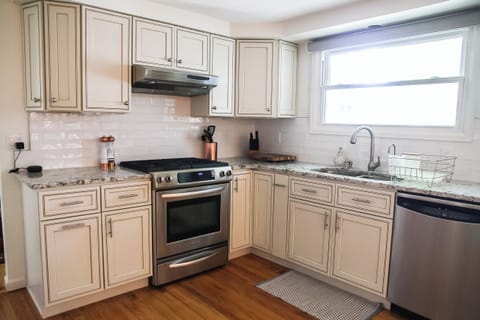 Fully stocked with stainless steel appliances, granite countertops & gas range
