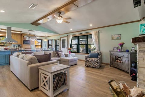 Open-concept living room, kitchen, and dining area designed for comfort in this Grande Lagoon vacation rental near Perdido Key. Enjoy Smart TVs, a fully equipped kitchen, and space for shared meals just minutes from Johnson Beach and NAS Pensacola.