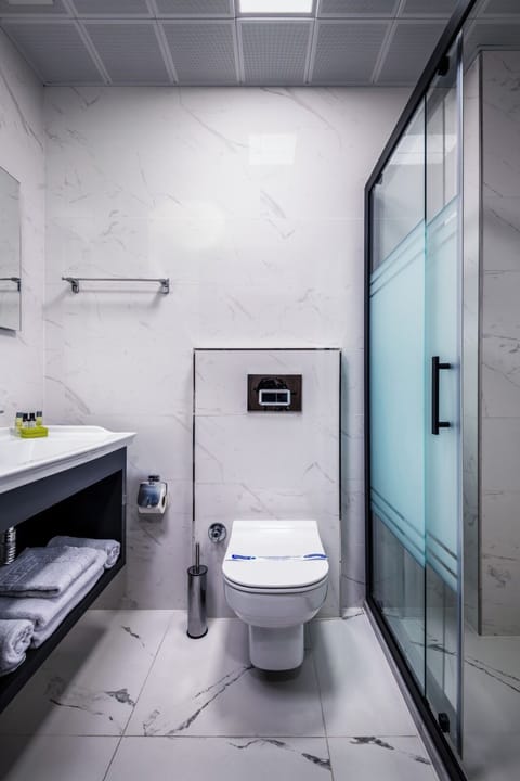 Shower, hair dryer, slippers, towels