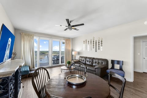 Relax in this bright living room with balcony views and modern furnishings.