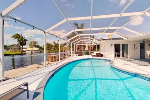 Pool Deck with Weber grill, loungers, and comfortable sectional seating