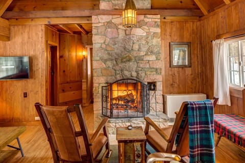 Cozy living room adjacent to kitchen and dining area with wood burning stone fireplace, SmartTV and dining area!
