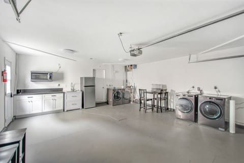 GARAGE with Additional refrigerator, sink, microwave and 2 washing machines and dryers.