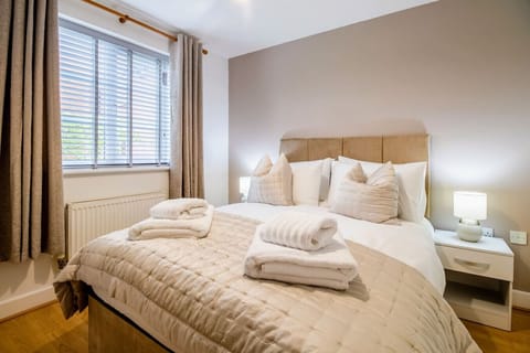 Bedroom one features a comfortable double bed with fresh linen and towels provided.
