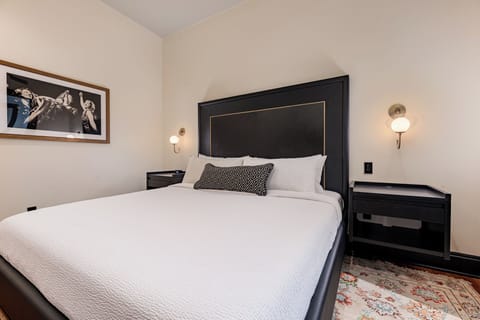 Bedroom 1 - King bed featuring a built-in wardrobe and flat-screen TV.