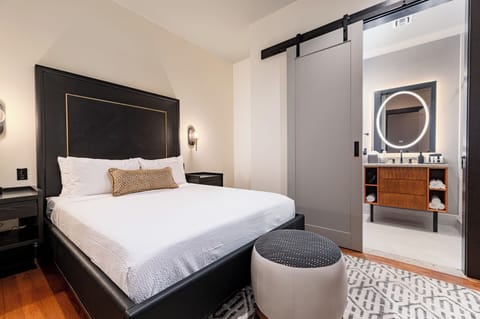 Bedroom 1 - Queen bed featuring a built-in wardrobe, flat-screen TV, and en-suite bathroom.