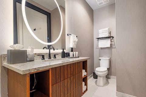 Bathroom 1 - Contemporary bathroom with ambient lighting and complimentary toiletries—ideal for unwinding after a day of exploring the city.