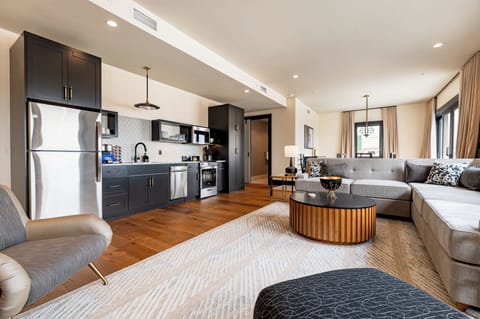 Expansive penthouse suite featuring a large living and dining area with a private patio, perfect for entertaining and accommodating large groups.