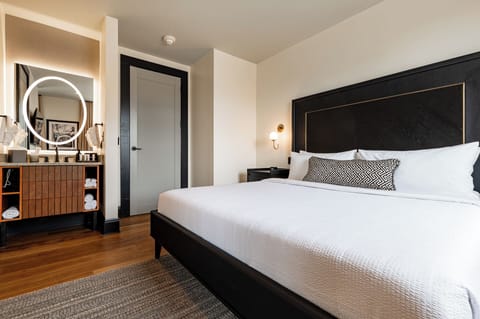 Bedroom 1 - King bed featuring a built-in wardrobe, flat-screen TV, and en-suite bathroom.