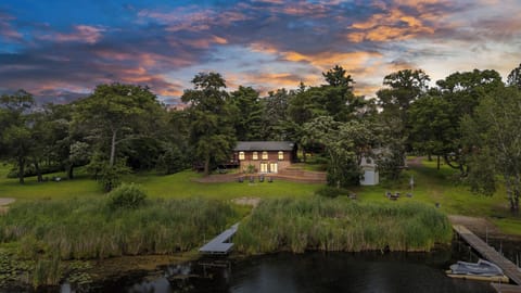 The sun sets over Perch Lake, Whispering Pines glows with warmth.