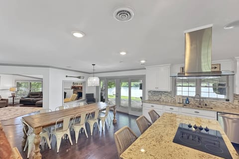 Open concept kitchen, dining and living space - steps away from covered patio with 180 degree view of lake